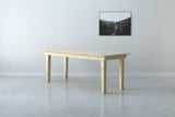 A handmade modern farmhouse style wooden dining table from solid pine wood.