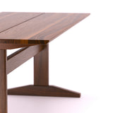 A handmade modern farmhouse style wooden dining table from solid walnut wood.