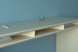 A handmade modern minimalist wooden desk in an architectural style made from maple wood.