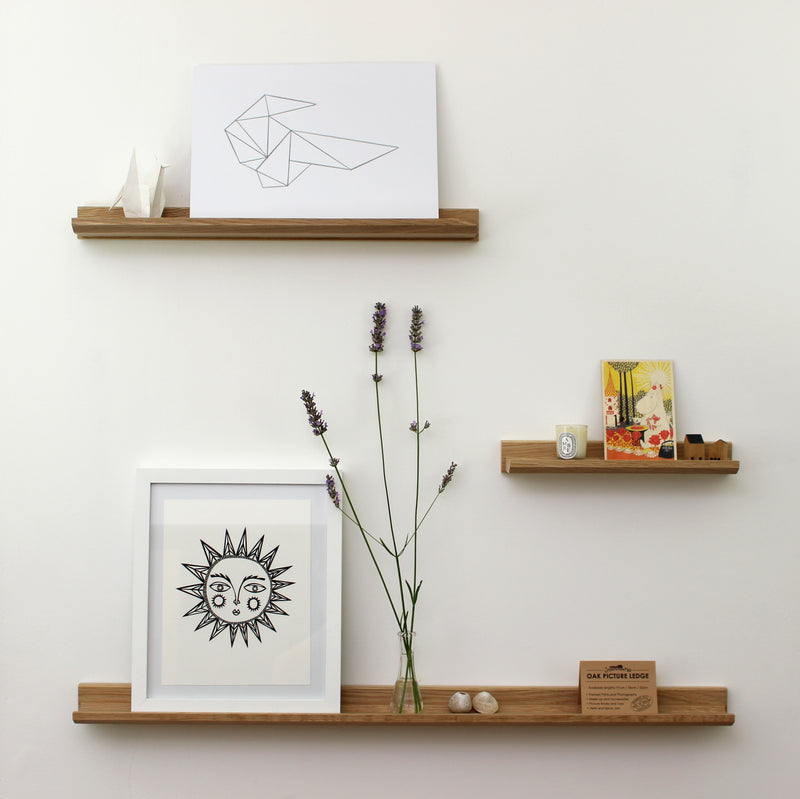 A solid oak picture ledge for displaying pictures on the wall